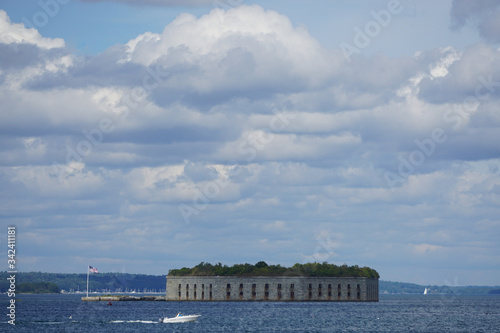 South Portland, Maine, USA: View of Fort Gorges, 1864, under dramatic cloud formations in Casco Bay, Maine.