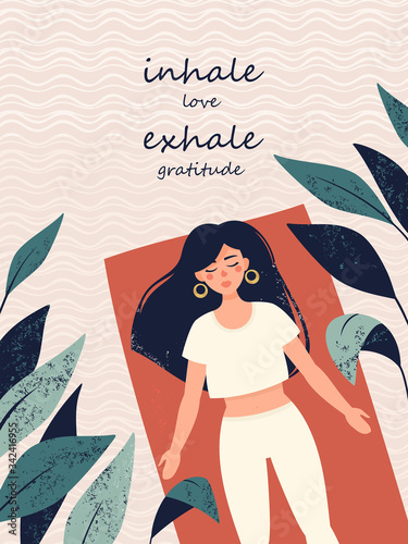 Vector woman is doing yoga in shavasana pose in the rug surrounded tropical plants and text inhale love exhale gratitude photo