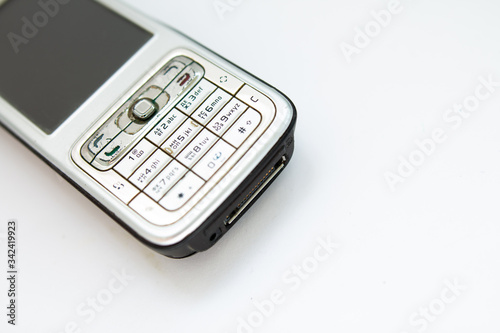 old push-button smartphone on a white background