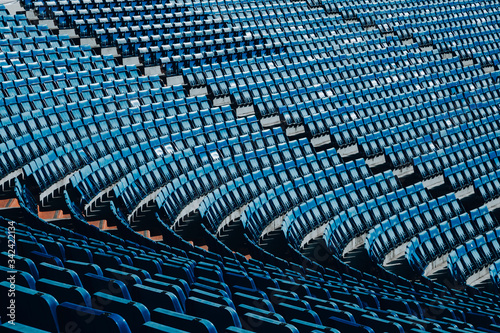 Empty soccer stadium grandstand  blue chairs  empty chairs for confinement