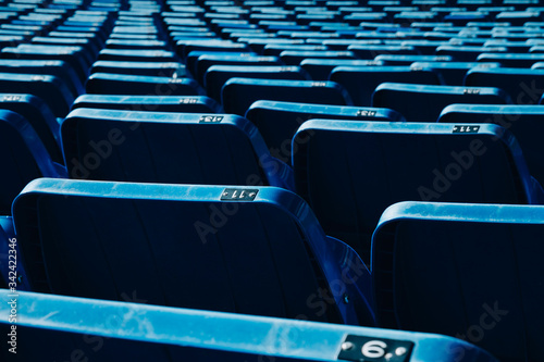 Empty stadium chairs, blue chairs for football fans, empty chairs for confinement