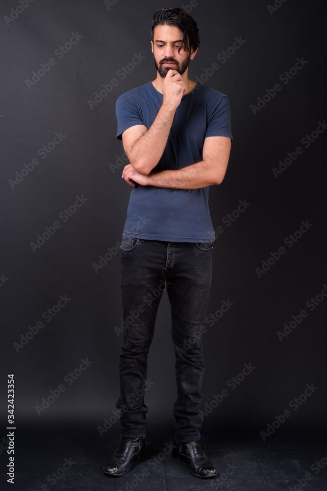 Full body shot of handsome bearded Persian man Full body shot of handsome bearded Persian man