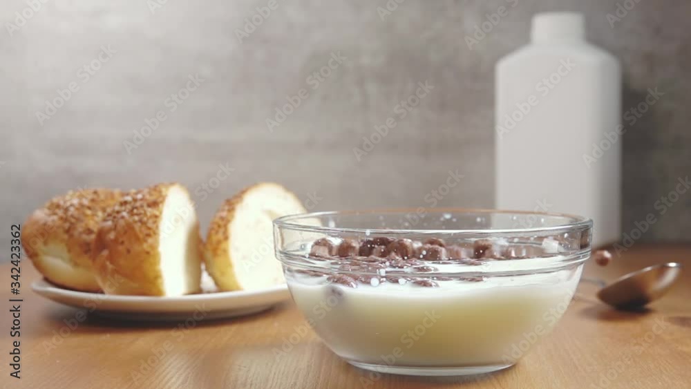 Chocolate Corn Balls Falling Into Milk. Slow Motion Chocolate Corn Balls Falling Into Milk. Slow Motion