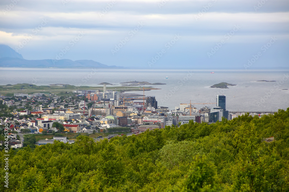 View over the cityscape of Bodo, Norway. Houses in the foreground & the sea & mountains in the background, Scandinavia. 
