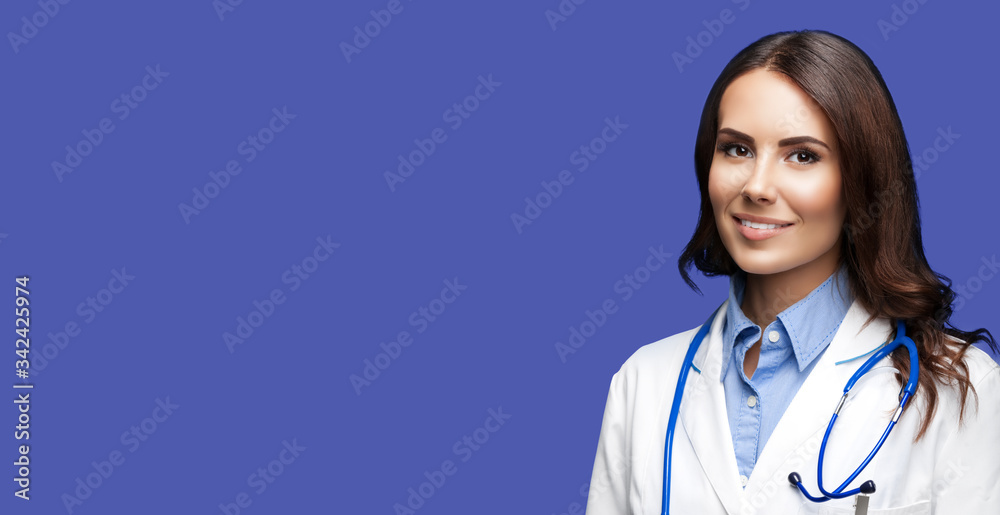 Portrait picture of happy smiling female doctor in white uniform coat and stethoscope, standing over dark blue color background. Healthcare, medical, medicine specialist - concept. Copy space. Portrait picture of happy smiling female doctor in white uniform coat and stethoscope, standing over dark blue color background. Healthcare, medical, medicine specialist - concept. Copy space.
