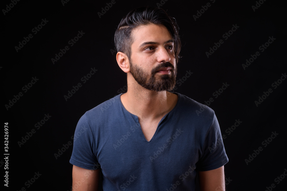 Face of handsome bearded Persian man thinking