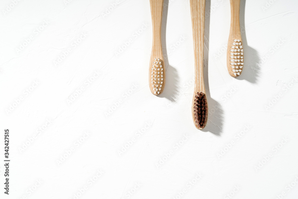 Fotografie Three eco natural tothbrushes on white background