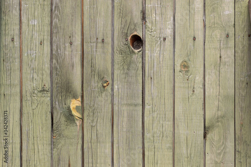 old wooden wall texture with peeling olive color paint