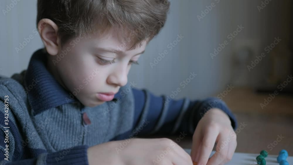 Boy does homework from plasticine. Schoolboy models geometric shapes from matches and plasticine. Boy does homework from plasticine. Schoolboy models geometric shapes from matches and plasticine.