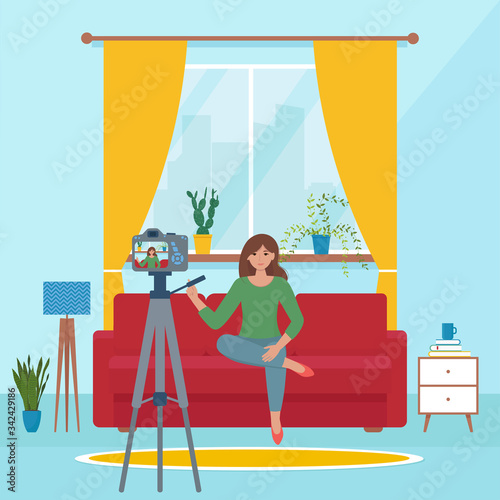 Woman video blogger recording video with camera at home. Cute vector illustration in flat style. Quarantine, stay at home concept