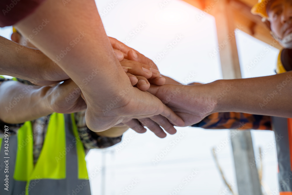 Engineers join hands to build successful projects,Team job of teamwork engineer work together in a construction site,Teamwork concept.