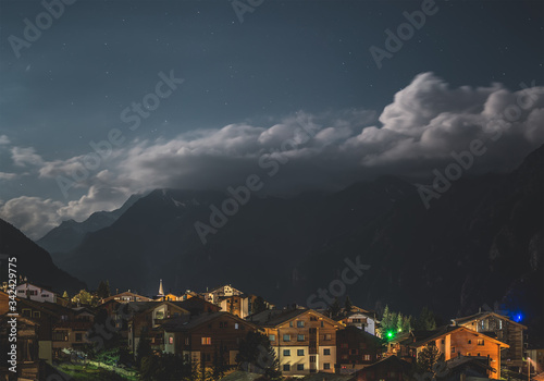 view of a village in switzerland, night landscape in the mountains