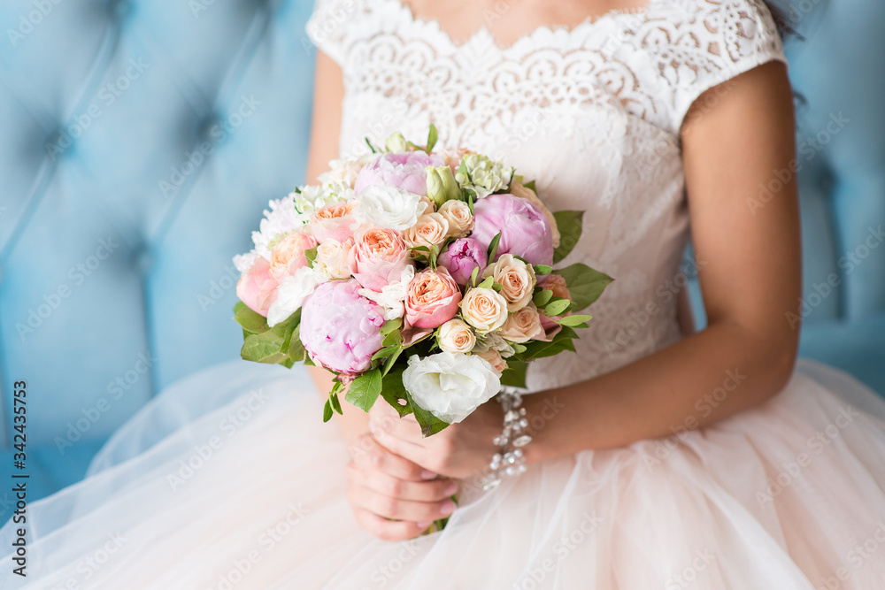 Beautiful wedding bouquet in the hands of the bride Beautiful wedding bouquet in the hands of the bride