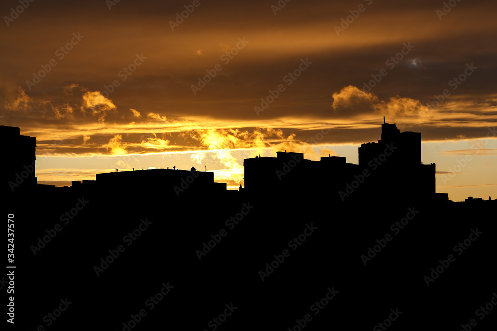 Black silhouette of the city at sunset.