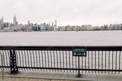 Hoboken, United States - April 19th, 2020 - Sign on the Hoboken Waterfront outlines the new social distancing guidelines photo