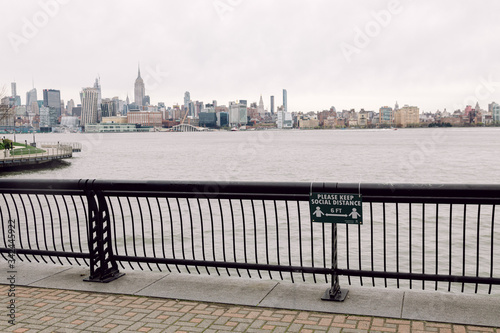 Hoboken, United States - April 19th, 2020 - Sign on the Hoboken Waterfront outlines the new social distancing guidelines © tisaeff