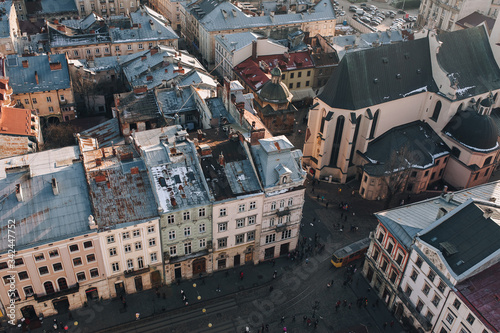 View of the old city and people from above, from the observation tower of the town hall. Lviv, Ukraine, winter panorama.