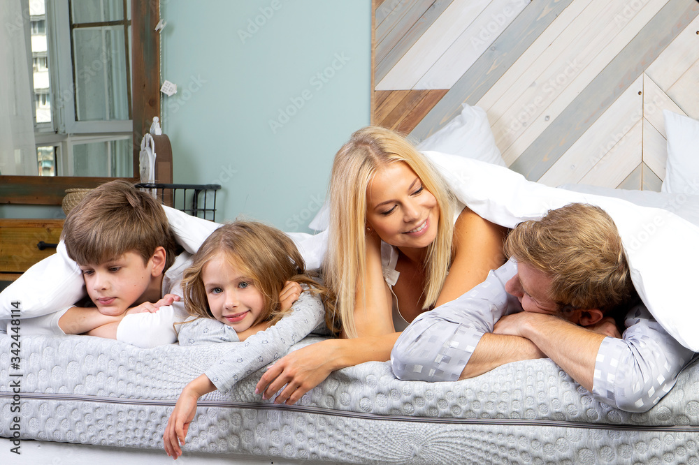 Father, mother, son and daughter in bedroom Father, mother, son and daughter in bedroom