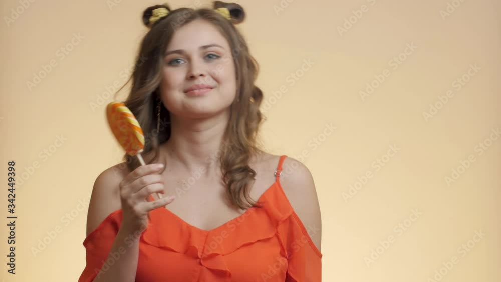 cute girl with caramel candy on colored studio background, young happy woman have fun with sweet lollipop, concept positive mood cute girl with caramel candy on colored studio background, young happy woman have fun with sweet lollipop, concept positive mood