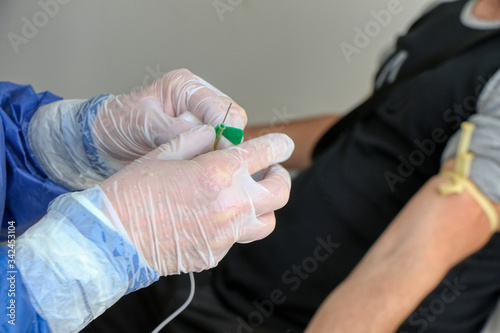 Nurse takes a blood sample from a patient for a blood test