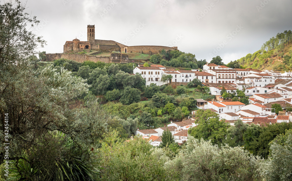 a view of Almonaster la Real town with it's hilltop mosque on a cloudy day, province of Huelva, Andalusia, Spain