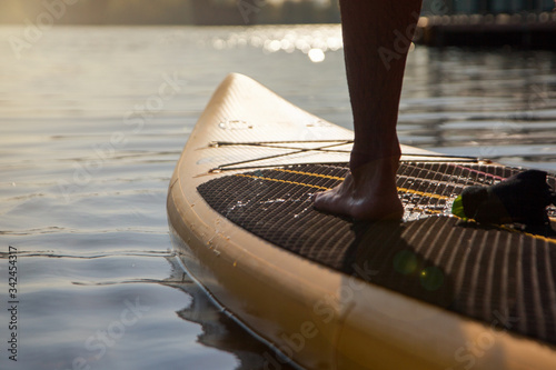 Fototapeta Naklejka Na Ścianę i Meble -  Paddleboarding on lake during sunset