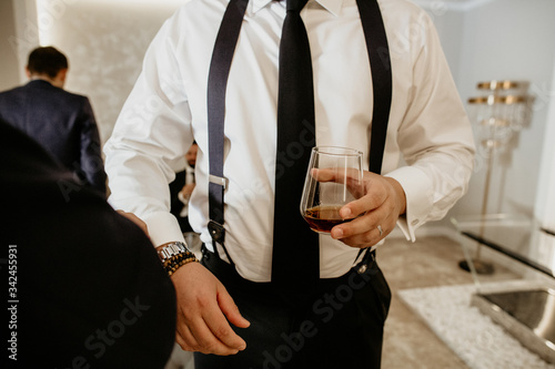 man holding glasses with alcoholic drink