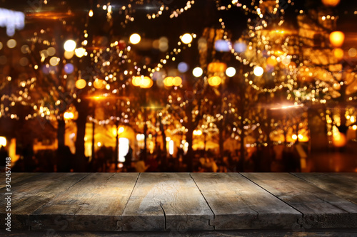 background Image of wooden table in front of street abstract blurred lights view