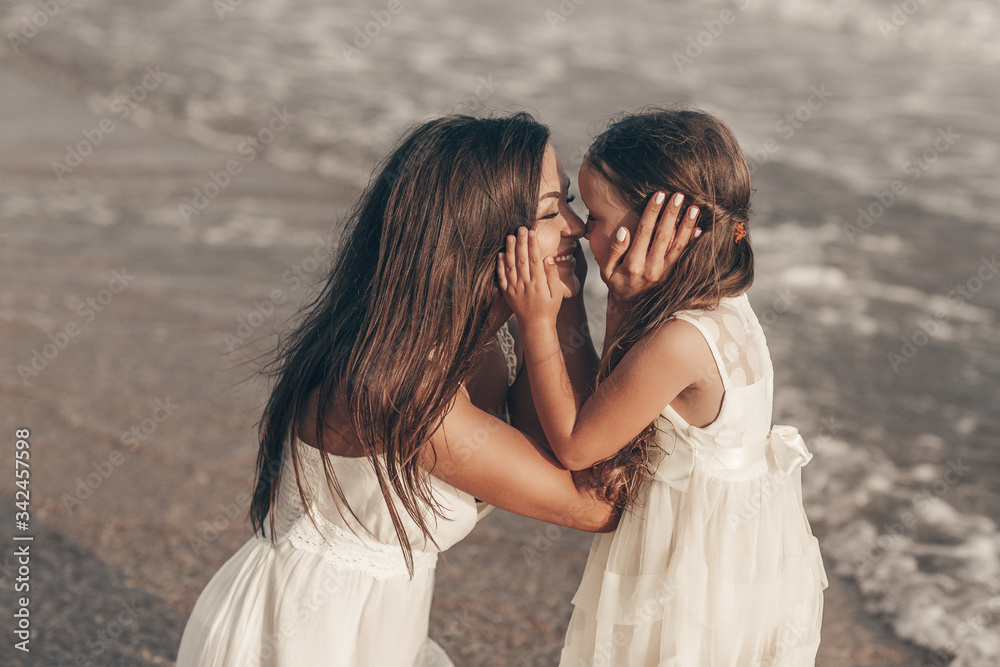 Happy mother and daughter enjoying sunny day on the beach Happy mother and daughter enjoying sunny day on the beach