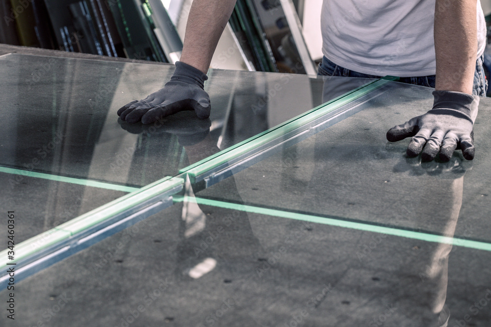 glazier breaking glass on a professional table - obrazy, fototapety, plakaty 