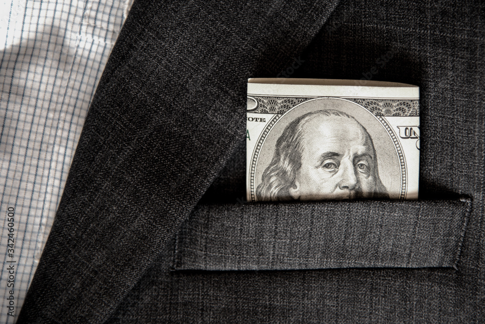 Abstract image with eyes on the banknote 100 dollars in the pocket of jacket (corruption, lobbying, bribery - concept).
