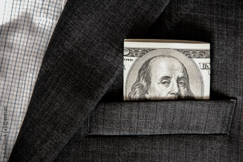 Obraz na płótnie Abstract image with eyes on the banknote 100 dollars in the pocket of jacket (corruption, lobbying, bribery - concept). w salonie