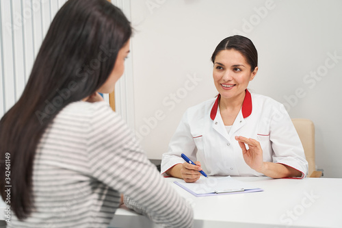 Positive delighted brunette woman working in clinic