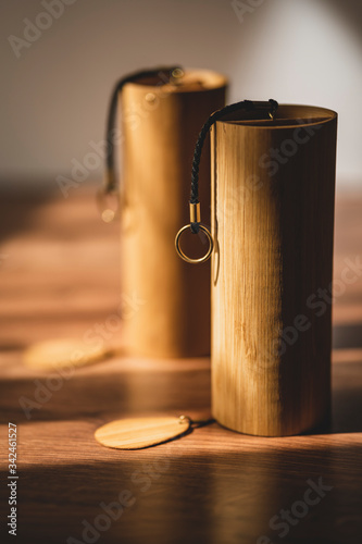 Hand made Koshi chimes musical instruments made from bamboo in beautiful and dramatic sunlight. Koshi bell with crystalline relaxing sound that induces a meditative state in yoga sessions.