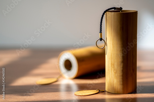 Beautiful hand made Koshi chimes musical instruments made from bamboo in a beautiful and dramatic sunlight. Koshi bell with crystalline relaxing sound that induces a meditative state in yoga sessions. photo