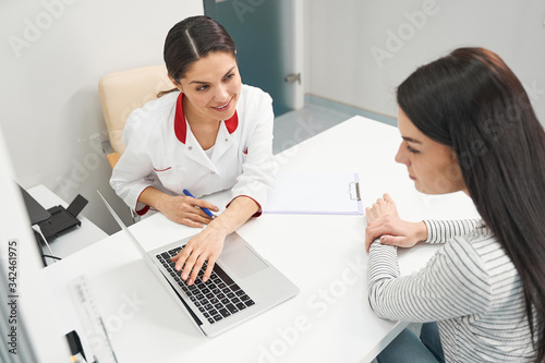Fényképezés Positive delighted therapist demonstrating results of analysis