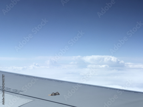 view from window on the wing of an airplane and the endless sky