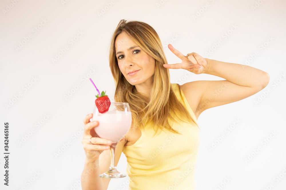 Pretty woman drinking having a strawberry smoothie Pretty woman drinking having a strawberry smoothie