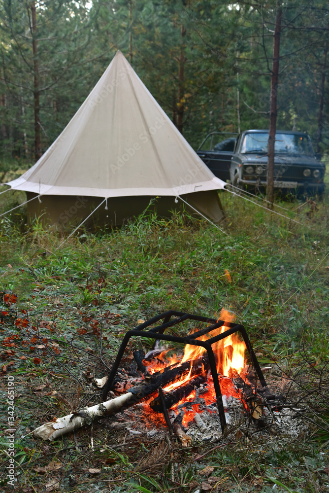 Tent and bonfire in the autumn taiga. Tent and bonfire in the autumn taiga.