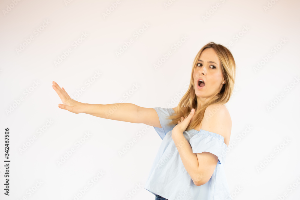 Beautiful woman with blue shirt making gesture of surprise Beautiful woman with blue shirt making gesture of surprise