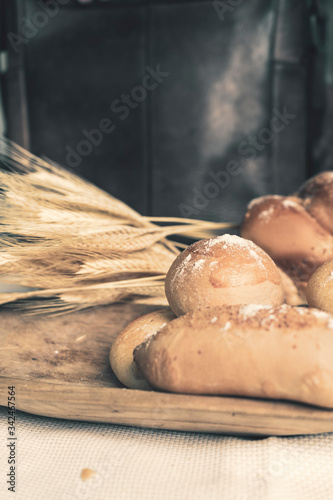 Baked breads on wooden table background.