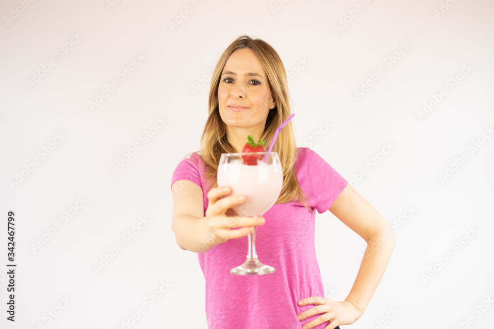 Beautiful woman drinking a strawberry smoothie Beautiful woman drinking a strawberry smoothie