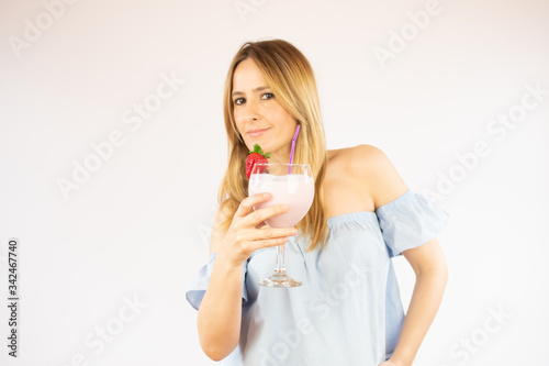 Beautiful woman drinking a strawberry smoothie