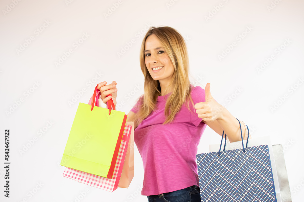 Pretty shopping woman in pink shirt with bags in hand Pretty shopping woman in pink shirt with bags in hand