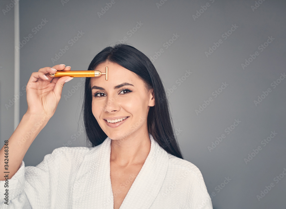 Attractive girl with a massager looking ahead Attractive girl with a massager looking ahead