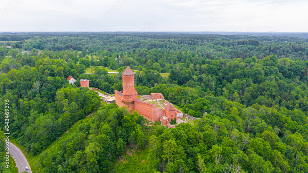Panoramic aerial view photo from flying drone  over River Gauja valley, with Turaida Castle in the middle of it during sunny summer day, Sigulda, Latvia. (series)

