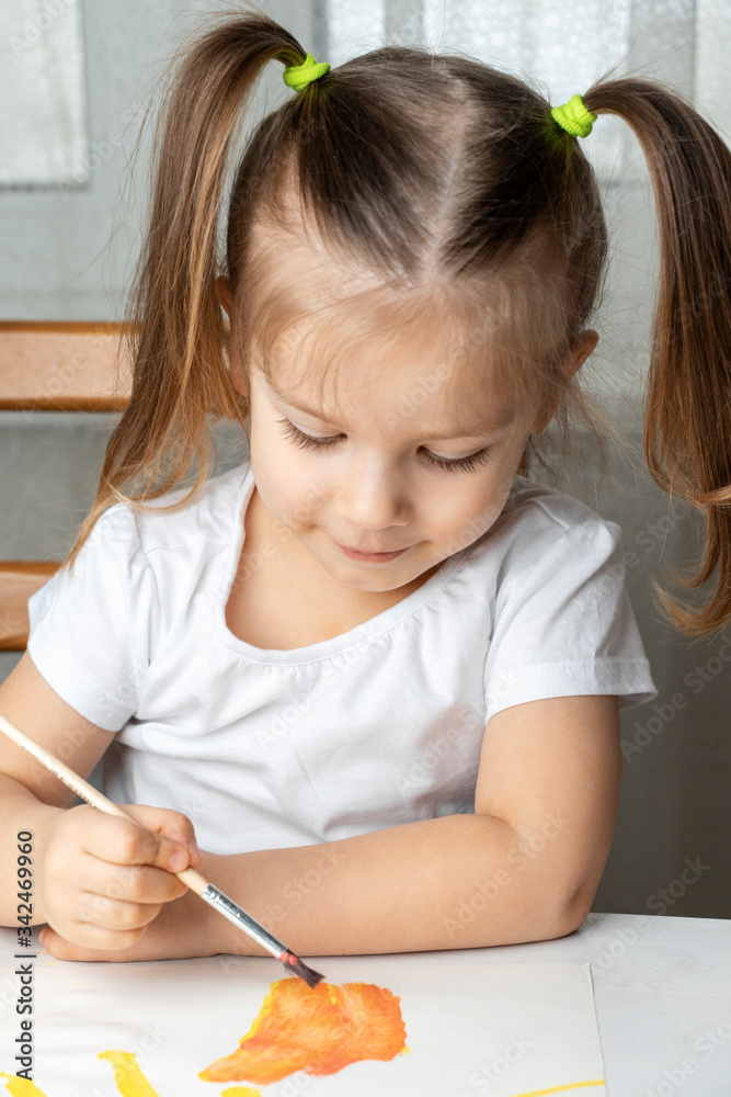what to do to the child during the period of quarantine and self-isolation, the girl plays and draws. sitting on a chair at the table what to do to the child during the period of quarantine and self-isolation, the girl plays and draws. sitting on a chair at the table