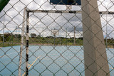 A Public Outdoor Basketball Court/Soccer Field stand Empty due to the Coronavirus Outbreak 
