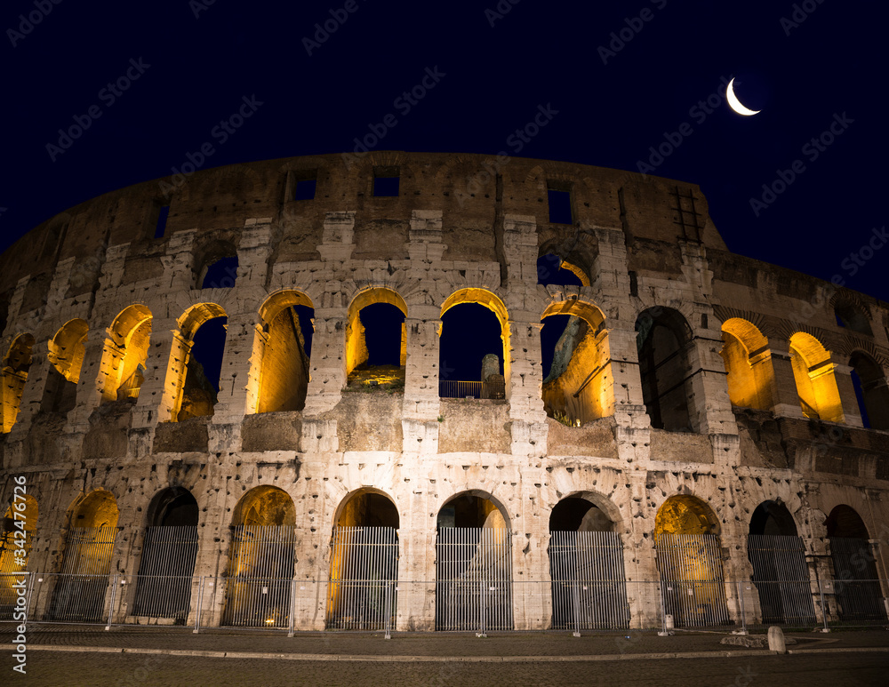 Ruins of the ancient Colosseum on a moonlit night, Rome, Italy