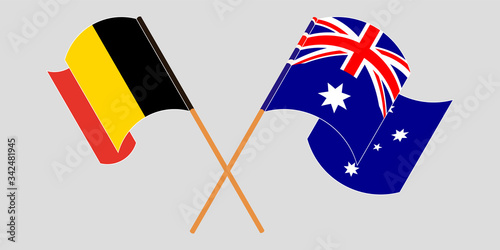 Crossed and waving flags of Australia and Belgium